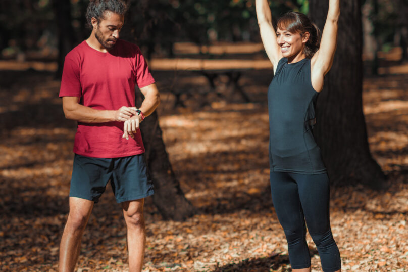 Young Couple stretching after training in the park